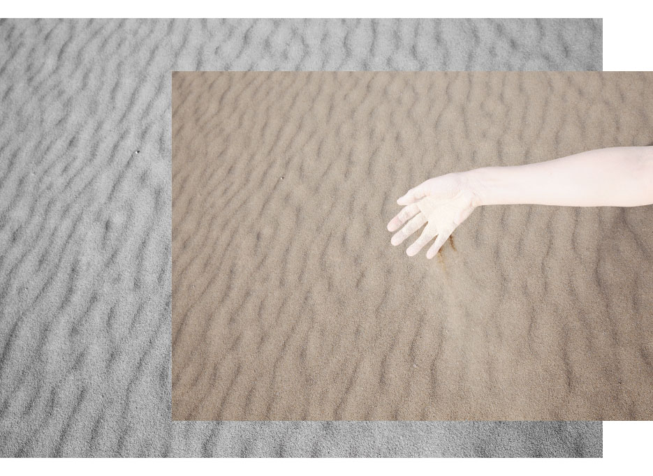 uebermorgen schnee, A.s overexposed arm is losing sand from her hand onto the desert ground