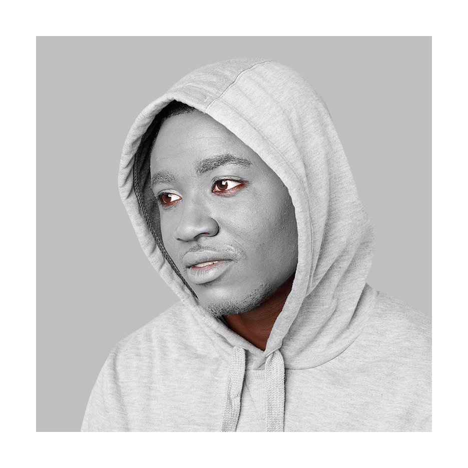 black man with grey facepaint in a grey hoody in front of a grey background looking absent